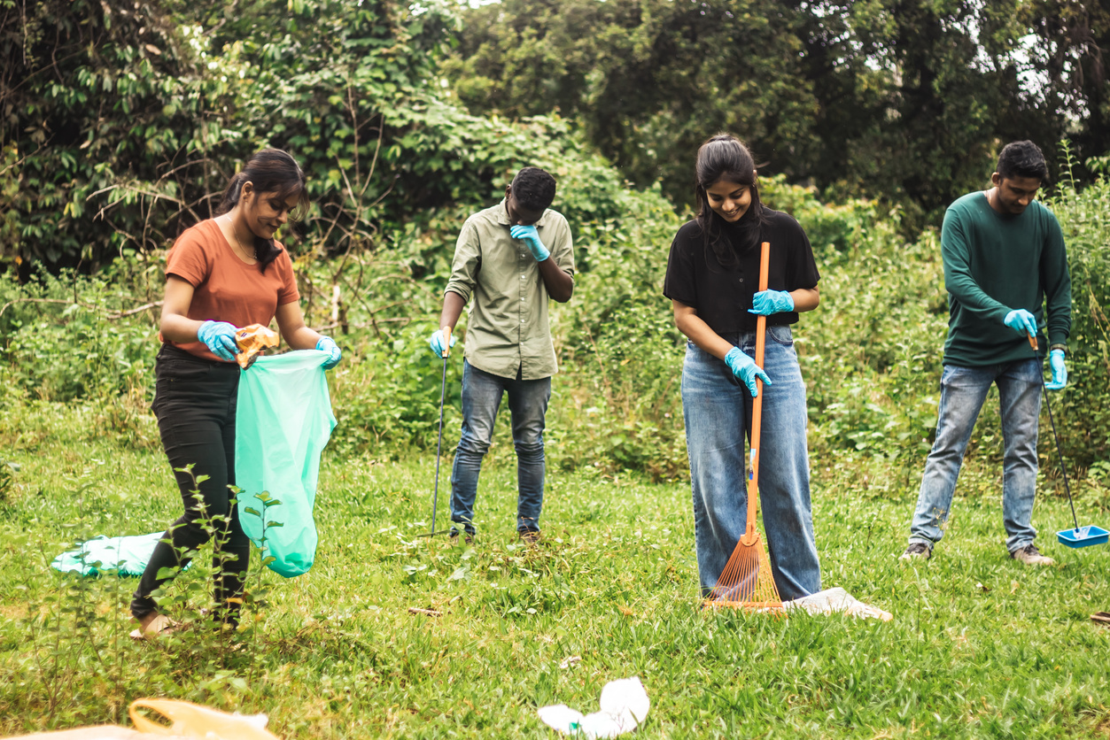 People Picking Up Trash in the Forest